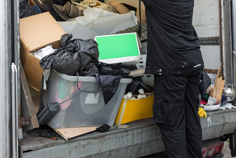 Worker,Unloading,Mixed,Waste,,Household,Items,,And,Rubbish,From,The